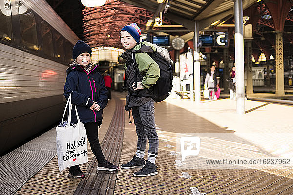 Brother and sister on train platform
