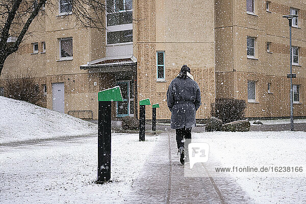 Woman walking in snowy weather