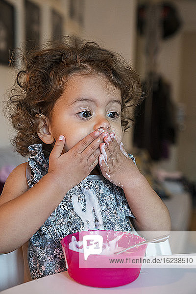 Toddler girl eating