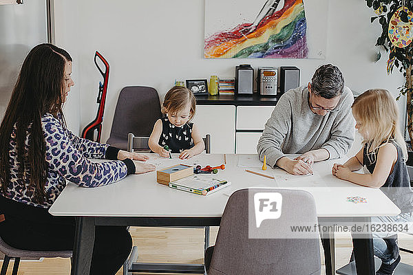 Parents with daughters drawing together