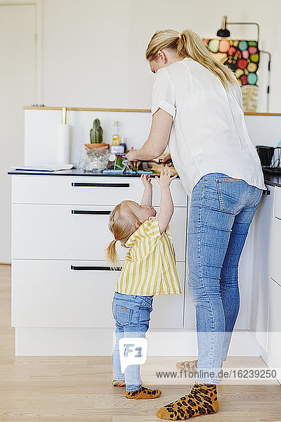Mother with daughter in kitchen