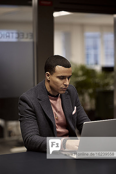 Man using laptop in office