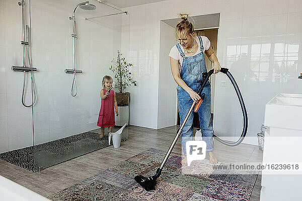 Mother and daughter cleaning bathroom