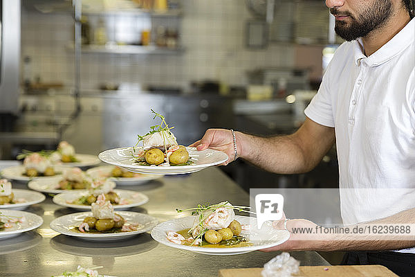 Chef holding plates with food