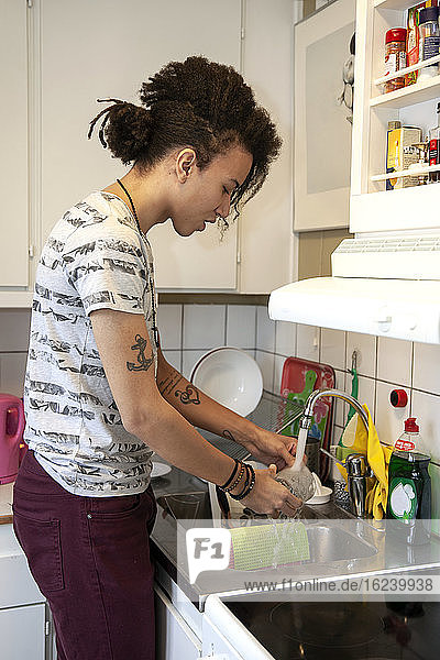Man washing dishes in kitchen