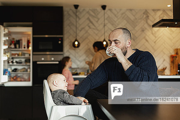 Father with baby at table