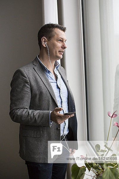 Businessman using cell phone hands-free device