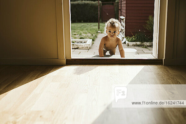 Toddler crawling through door