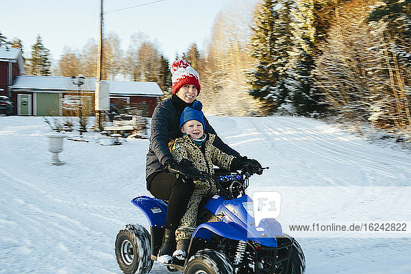Mother with daughter on quad