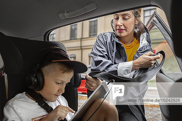 Boy in car wearing headphones