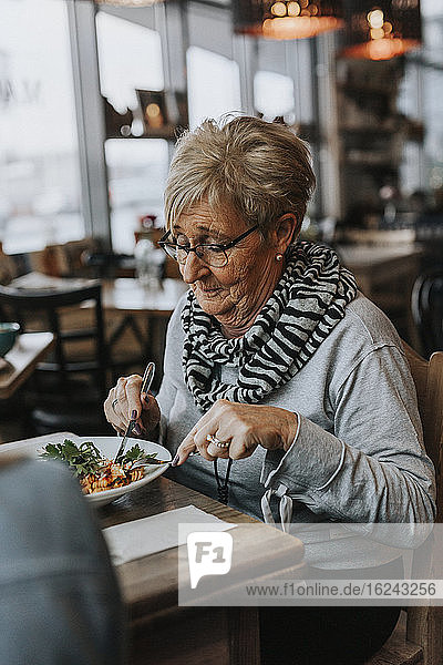 Woman having meal in cafe
