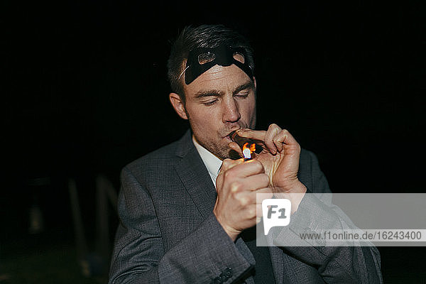 Man smoking cigar at party
