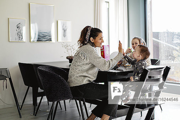 Mother with children at table