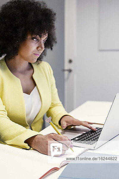 Woman using laptop in boardroom