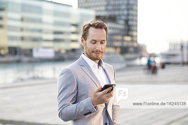 Businessman looking at cell phone