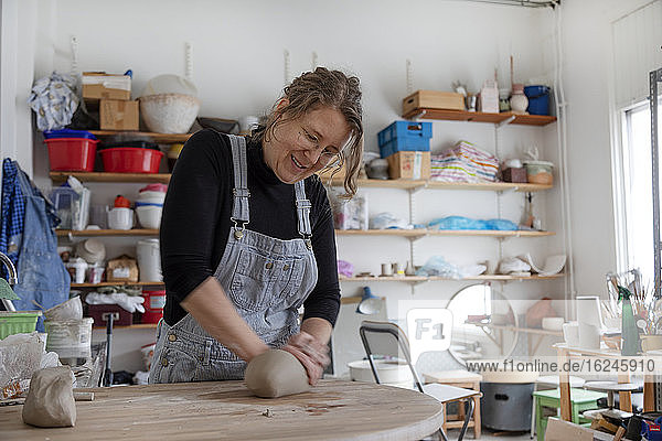 Woman preparing clay in workshop