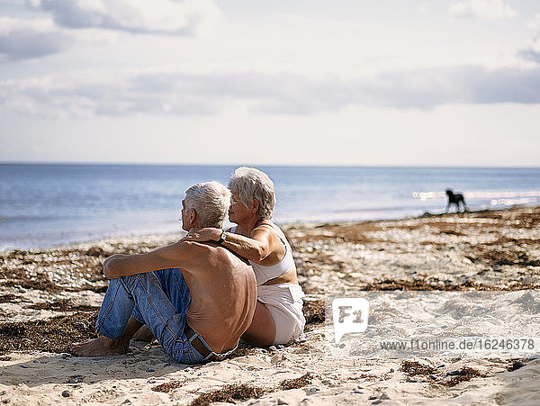 Old couple on sandy beach