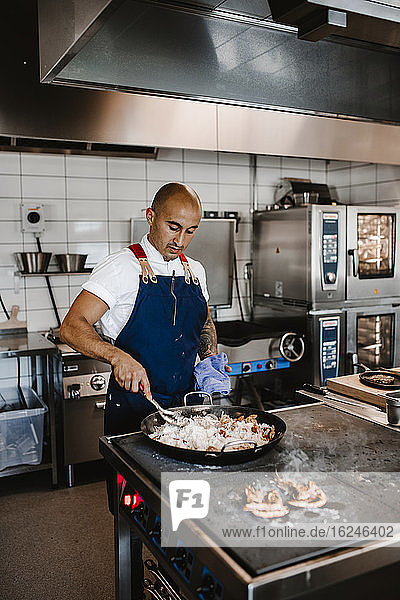 Chef preparing food in restaurant kitchen