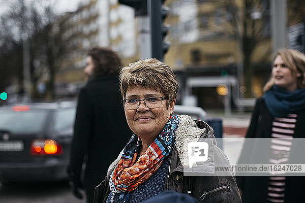 Mature woman smiling on street