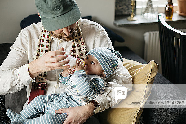 Vater füttert Baby