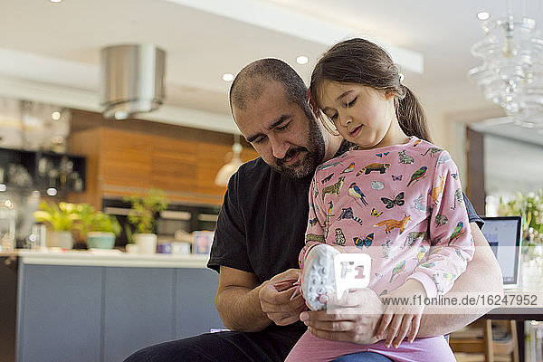 Father helping daughter to put shoes on