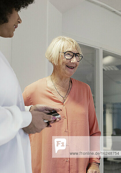 Smiling woman talking with colleagues