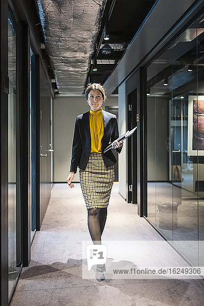 Businesswoman walking through corridor
