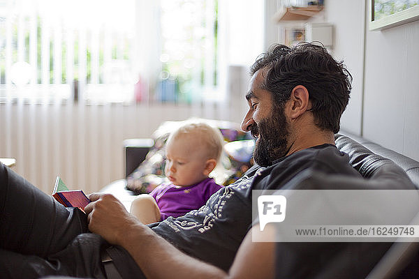 Father with baby girl on sofa