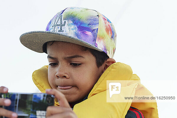Boy taking picture with cell phone