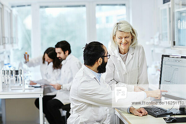 Coworkers talking in laboratory