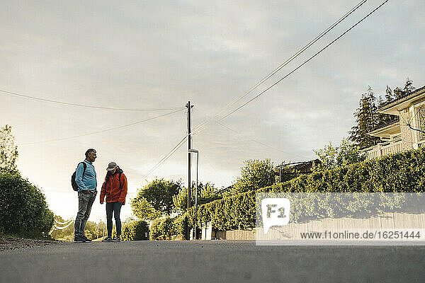 Couple of hikers standing on road