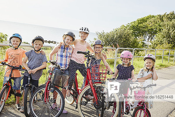 Children standing with bicycles