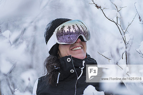 Smiling woman wearing ski goggles
