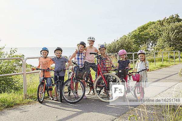 Children standing with bicycles