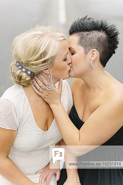 View of brides kissing