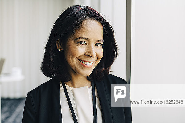 Close-up portrait of smiling businesswoman at workplace