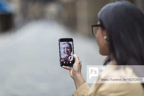 Women friends video chatting on smart phone screen