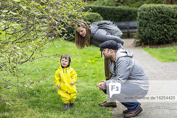 Family enjoying a spring day in the park with their young daughter; North Vancouver  British Columbia  Canada