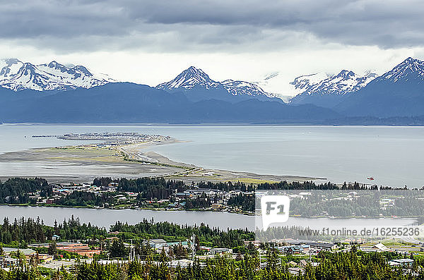 Aerial view of the city of Homer and the Homer Spit in Kenai Peninsula Borough  in Kachemak Bay with the Kenai Mountain Range in the distance; Kenai Peninsula  Alaska  United States of America