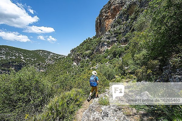 Hiker on a hiking trail  The Green Gorge  Garganta Verde  Sierra de Cádiz  Cadiz  Spain  Europe