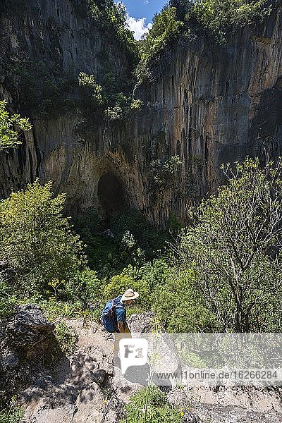 Hikers on trail in the gorge  rock faces of the Garganta Verde  Sierra de Cádiz  province of Cádiz  Spain  Europe