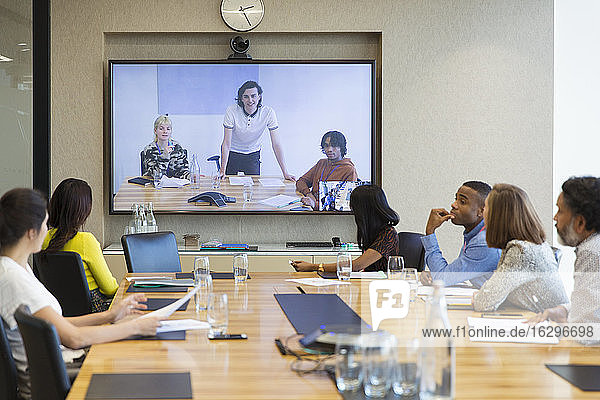 Business people video conferencing in conference room