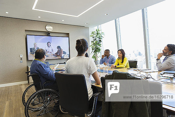 Business people video conferencing in conference room meeting
