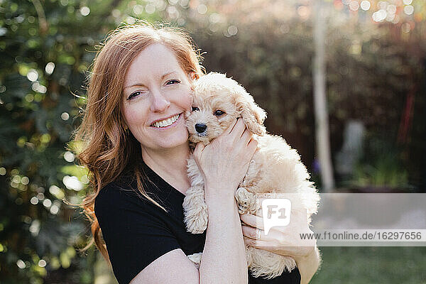 Beautiful woman with cute dog at back yard