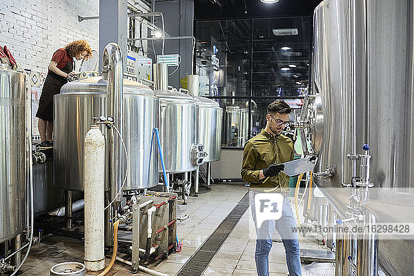 Man and woman working in craft brewery