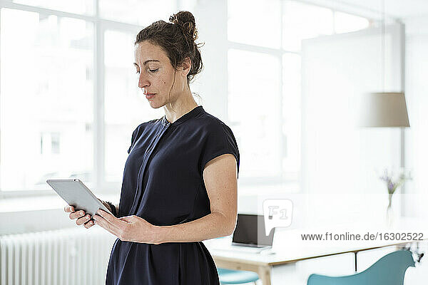 Female entrepreneur using digital tablet