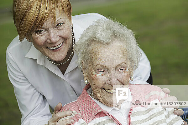 Germany  North Rhine Westphalia  Cologne  Senior woman and mature woman in park  smiling
