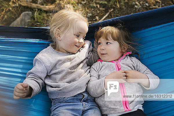 Two little girls (2-3) in hammock in Uinta-Wasatch-Cache National Forest