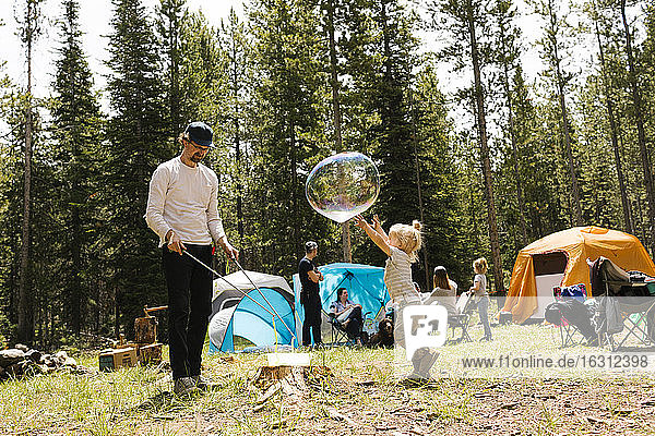 Mädchen (6-7) spielt große Seifenblase auf dem Campingplatz  Wasatch-Cache National Forest