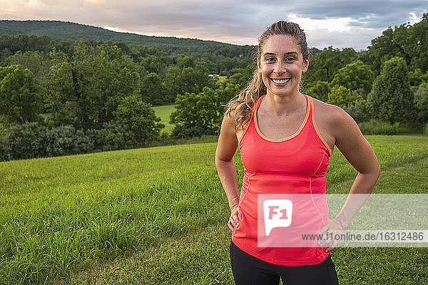USA  Woman in running outfit standing in field